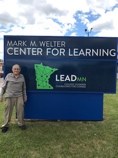 Dr. Welter standing in front of LeadMN sign