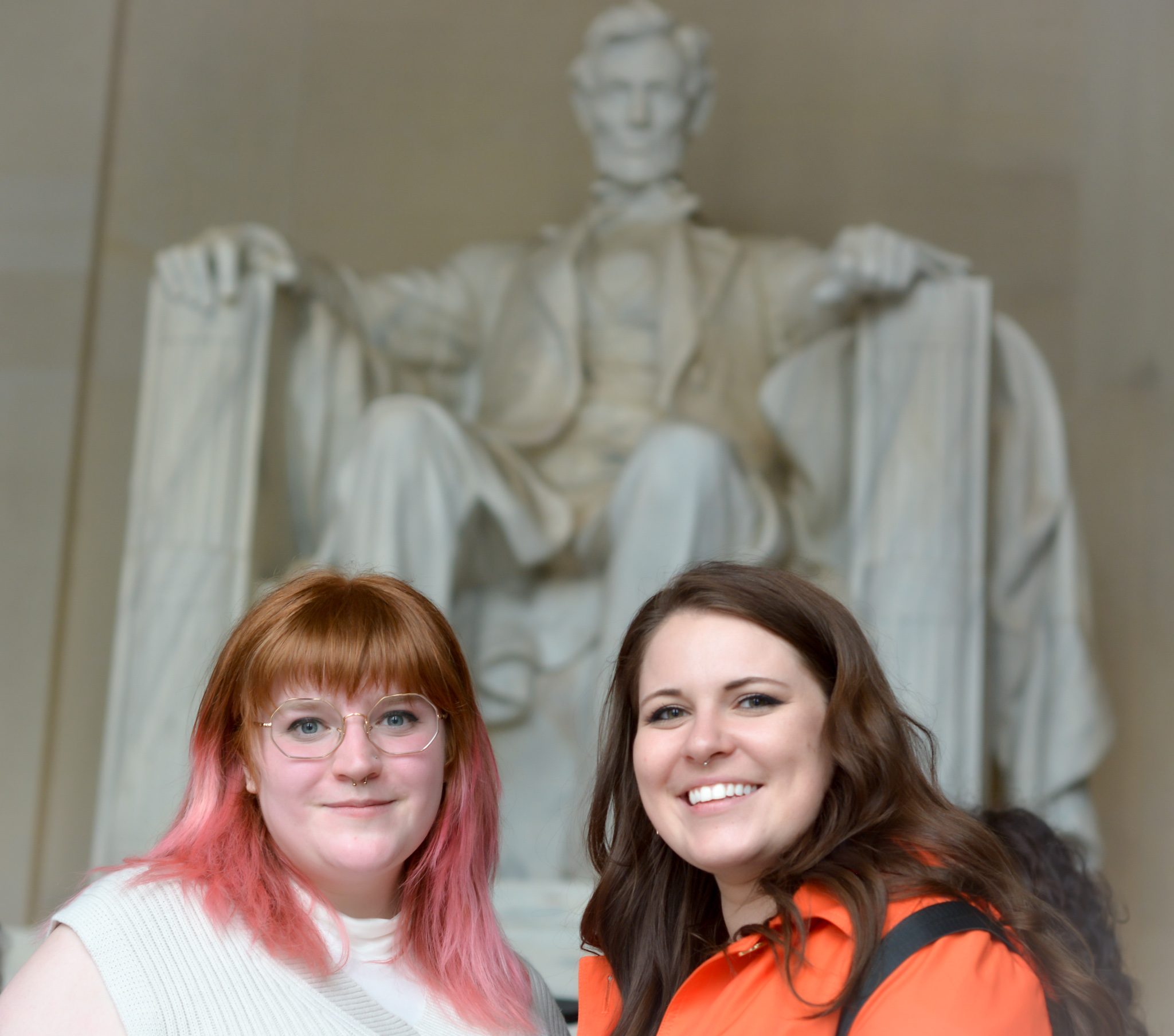 Henri and Ali Tomashek smile at the camera in front of the Lincoln Memorial in Washington D.C.