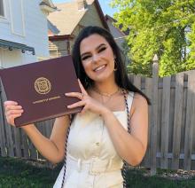 Bridget Ritzer smiling and holding diploma