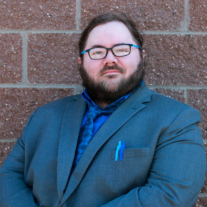 photo of alex bender, LeadMN president, against red/copper brick