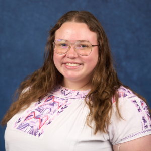 headshot of policy leadership associate JJ Hadley against a blue backdrop